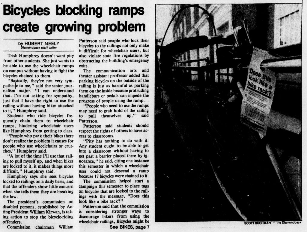 Article in a newspaper. The article is titled "Bicycles blocking ramps create growing problem/By Hubert Neely". Below that, the article is in two long columns. To the right of the columns, there is a black and white photo. It is a close up photo of a bicycle locked to a ramp, with a slip of paper on the ramp handle, right next to the bicycle, that reads "Does this look like a bike rack?" 